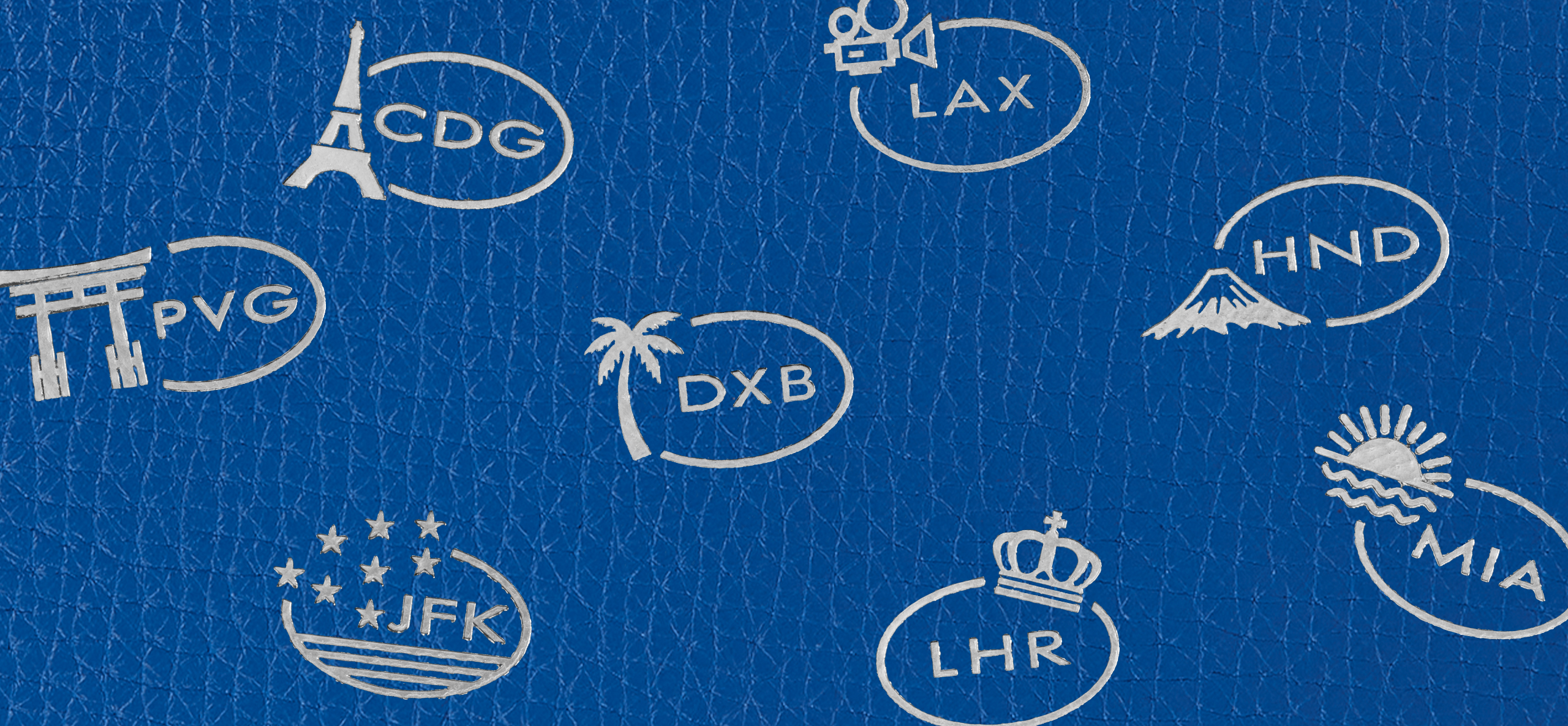 Auf blaues Leder gestickte Smythson-Reisezielmotive